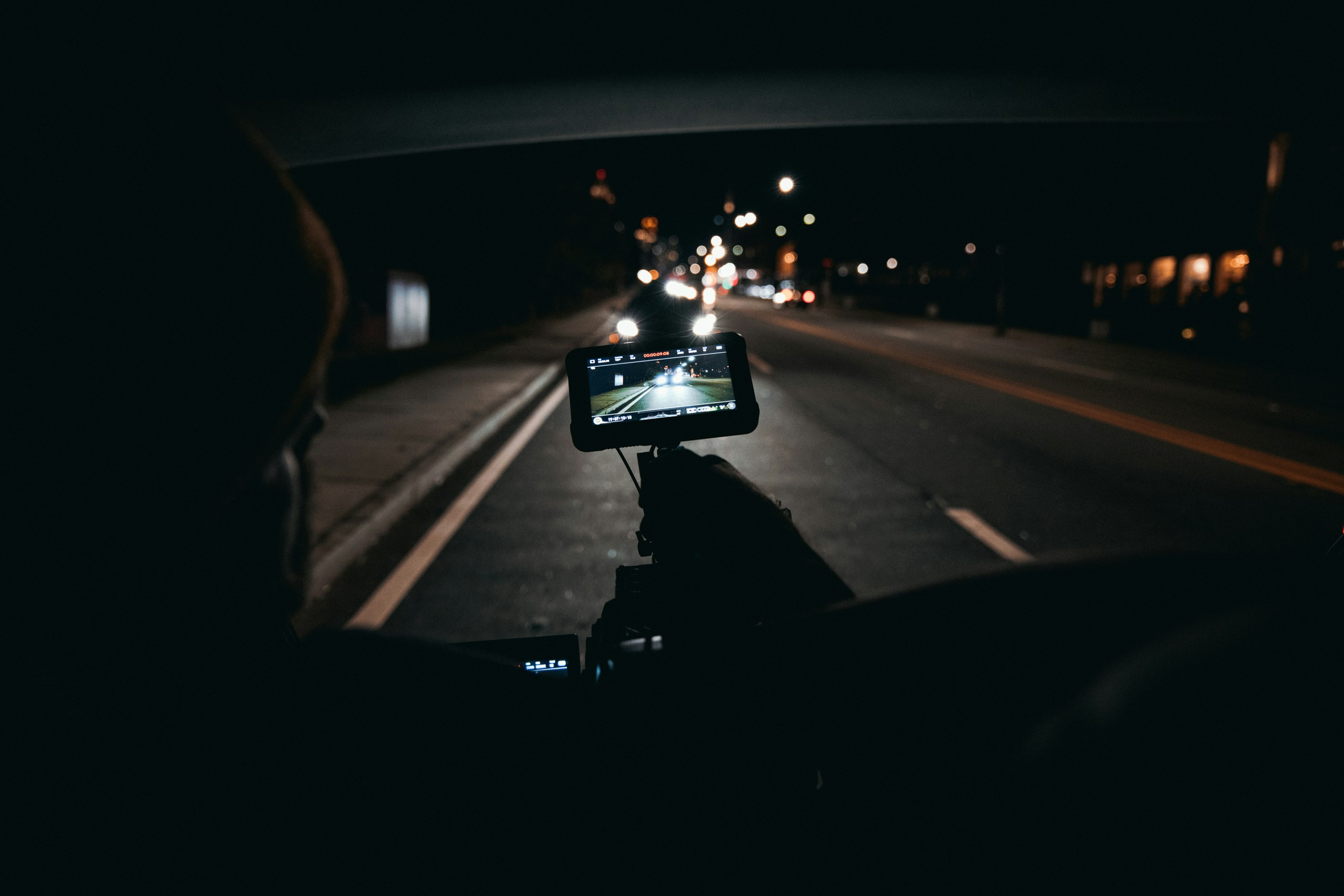 black car on road during night time